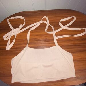 Cream tank top with adjustable straps.